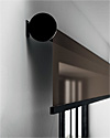 Side view of Girare Roller Shade showing round end cap with reverse roll configuration.